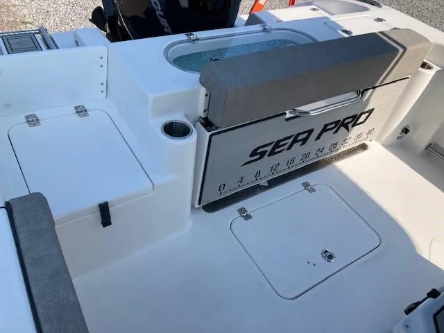 Slide: The Image of 2024 Sea Pro 242 DLX boat interior with seating and storage compartments. - 50