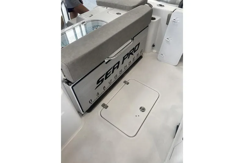 Slide: The Image of 2024 Sea Pro 242 Center Console boat interior with seating and storage. - 54