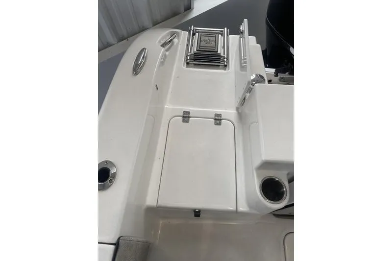 Slide: The Image of 2024 Sea Pro 242 Center Console boat deck with storage compartment and cup holder. - 55