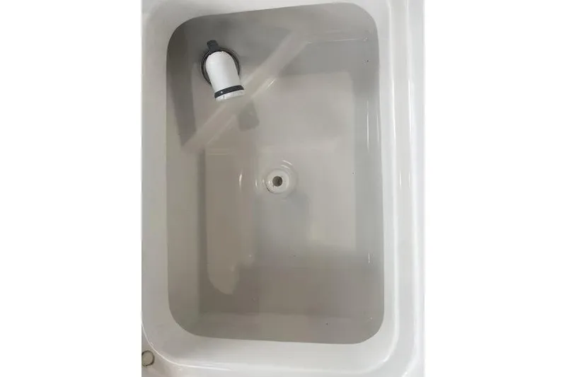 Slide: The Image of Livewell in 2024 Sea Pro 242 Center Console boat, featuring a clean, white interior. - 57