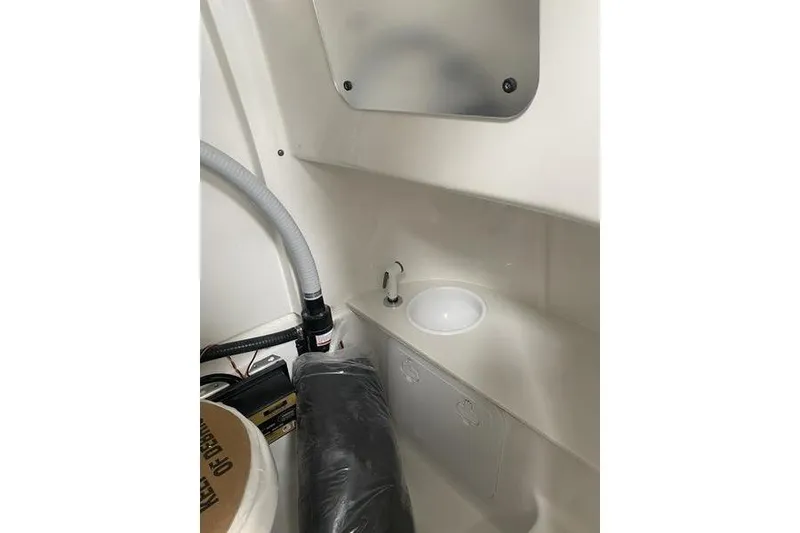 Slide: The Image of 2024 Sea Pro 242 Center Console interior with sink and storage area. - 61