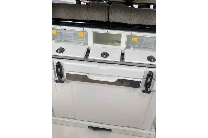 Slide: The Image of 2024 Sea Pro 242 Center Console storage compartments with secure latches and organized layout. - 64