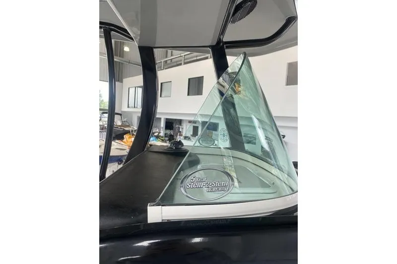 Slide: The Image of 2024 Sea Pro 242 Center Console boat with windshield and warranty sticker. - 65