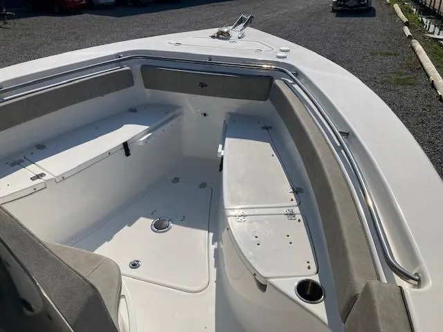 Slide: The Image of 2024 Sea Pro 242 Center Console boat displayed indoors on a trailer. - 7