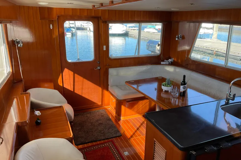 Slide: The Image of Luxurious 2012 Integrity 45 yacht interior with wood paneling and marina view. - 14