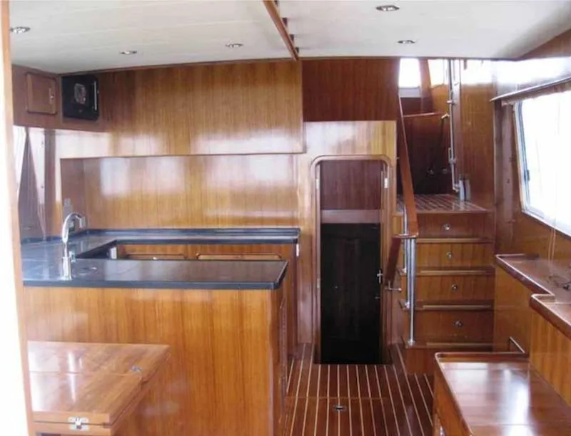 Slide: The Image of 2012 Integrity 45 yacht interior with wooden cabinetry and black countertops. - 17