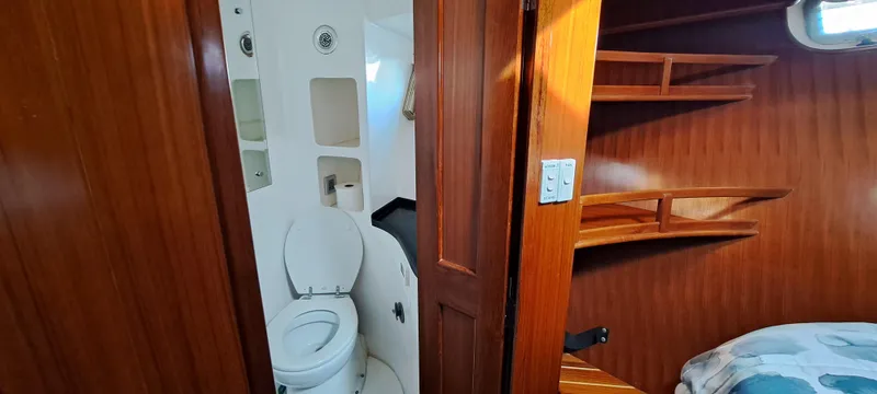 Slide: The Image of Interior of 2012 Integrity 45 boat showing bathroom and wooden cabin. - 20