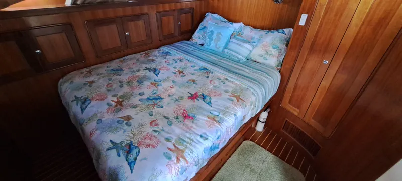 Slide: The Image of Cozy bedroom in 2012 Integrity 45 boat with floral bedding and wooden interior. - 23