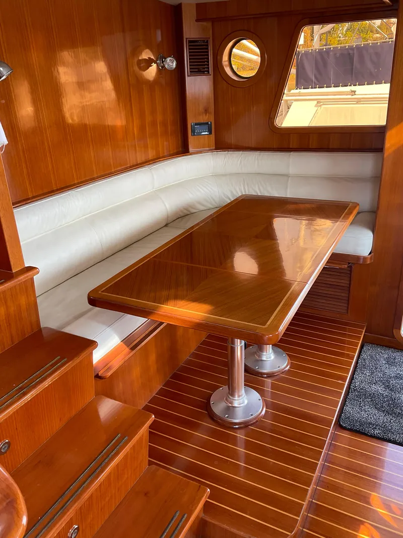 Slide: The Image of Luxurious interior of 2012 Integrity 45 yacht with wooden table and white leather seating. - 25