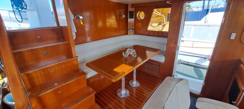 Slide: The Image of Luxurious interior of a 2012 Integrity 45 yacht with wooden finishes and cozy seating area. - 26