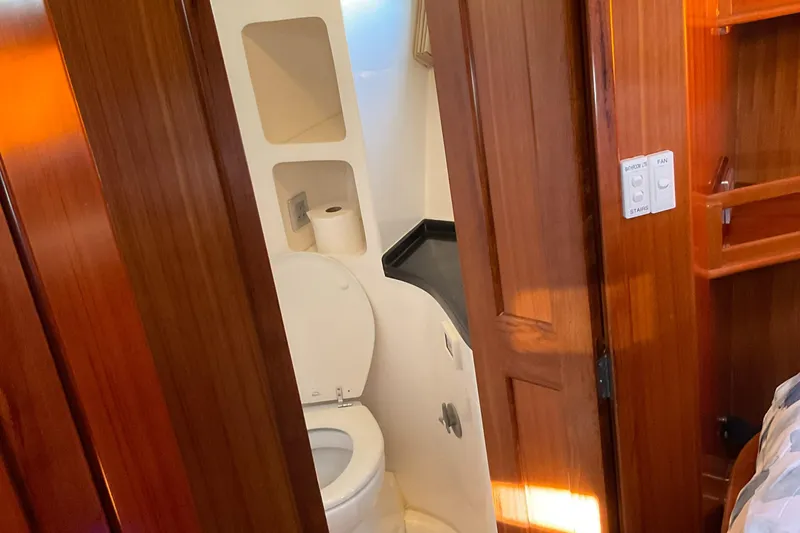 Slide: The Image of Compact bathroom in 2012 Integrity 45 yacht with wooden cabinetry and modern fixtures. - 33
