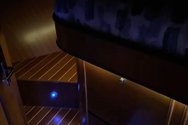 Slide: The Image of Dimly lit interior of 2012 Integrity 45 yacht with wooden steps and blue lights. - 35