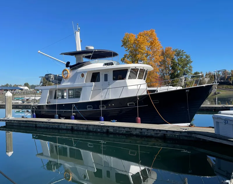 Slide: The Image of Integrity 45 yacht docked at marina, 2012 model, clear blue sky, autumn trees in background. - 4