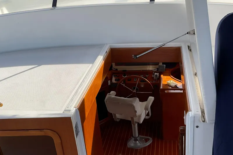 Slide: The Image of Interior helm of 2012 Integrity 45 boat with wooden accents and steering wheel. - 9