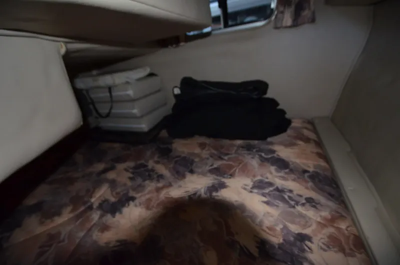 Slide: The Image of Interior cabin of 2000 Chaparral Signature 270 with floral bedding and storage. - 15