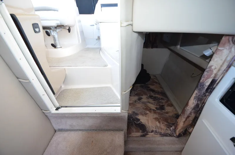 Slide: The Image of Interior view of 2000 Chaparral Signature 270 boat, featuring stairs and cabin area. - 16