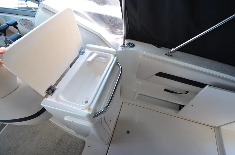 Slide: The Image of 2000 Chaparral Signature 270 boat interior with open storage compartment and sink. - 17