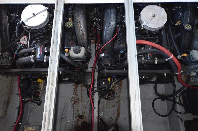 Slide: The Image of Engine compartment of a 2000 Chaparral Signature 270 boat, showing dual engines and wiring. - 18