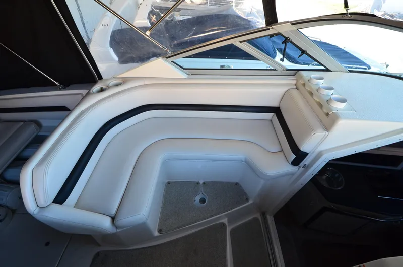 Slide: The Image of 2000 Chaparral Signature 270 boat interior with white seating and cup holders. - 9