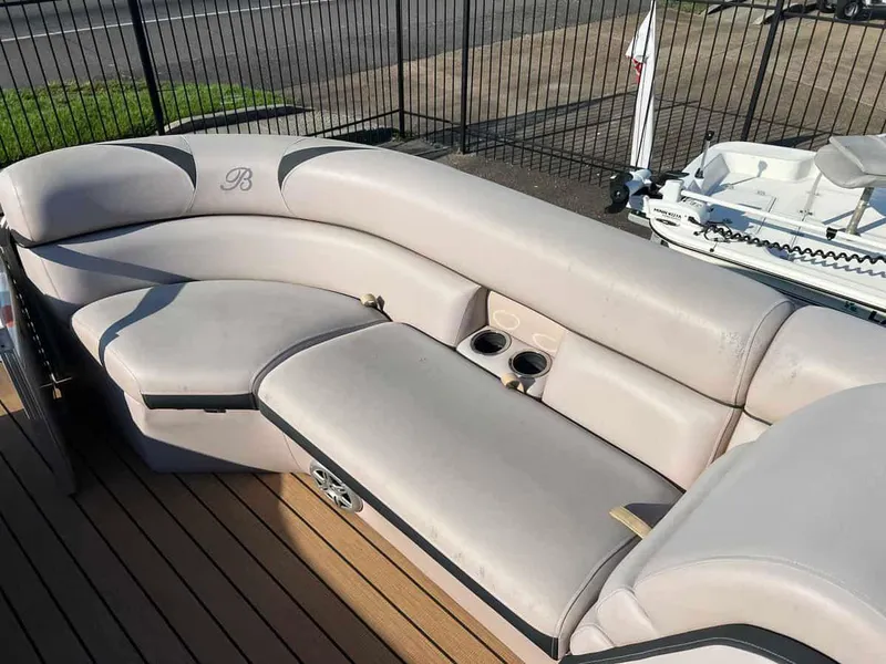 Slide: The Image of 2015 Berkshire 230 CL boat with beige seating and cup holders. - 5