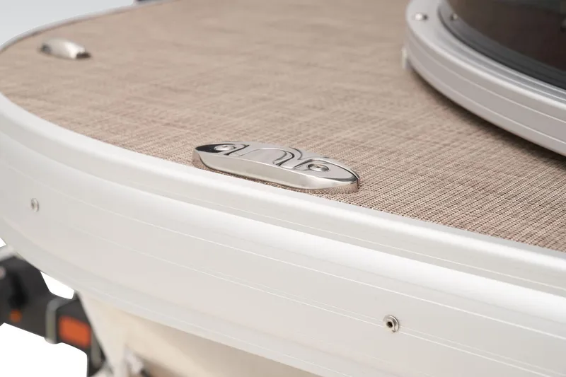 Slide: The Image of 2024 Sun Tracker SportFish 22 DLX boat deck with beige flooring and metal cleat. - 20