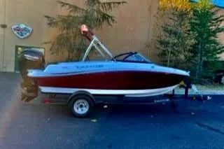 Slide: The Image of 2024 Tahoe 185 S boat with red and white design on a trailer. - 1