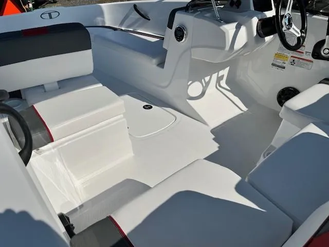Slide: The Image of 2024 Tahoe T16 boat interior with white and gray seating, steering console, and modern design. - 4
