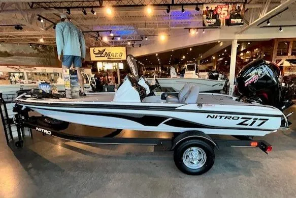 Slide: The Image of 2024 Nitro Z17 boat displayed in showroom, side view with sleek design. - 0