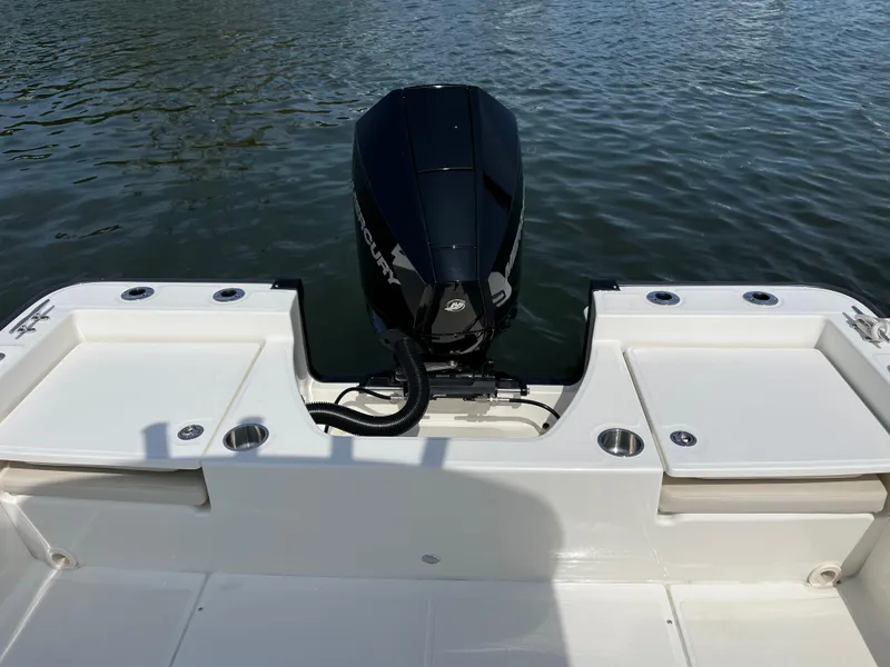 Slide: The Image of 2024 Boston Whaler 210 Montauk boat with outboard motor on calm water. - 12