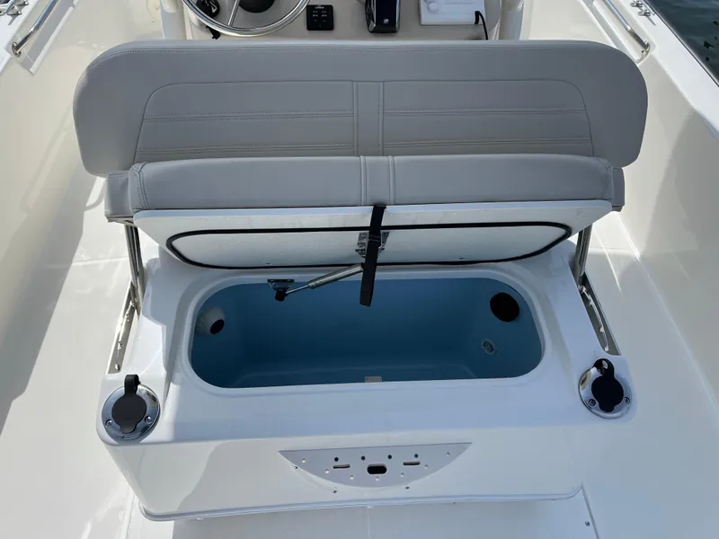 Slide: The Image of 2024 Boston Whaler 210 Montauk boat seat with storage compartment open. - 16