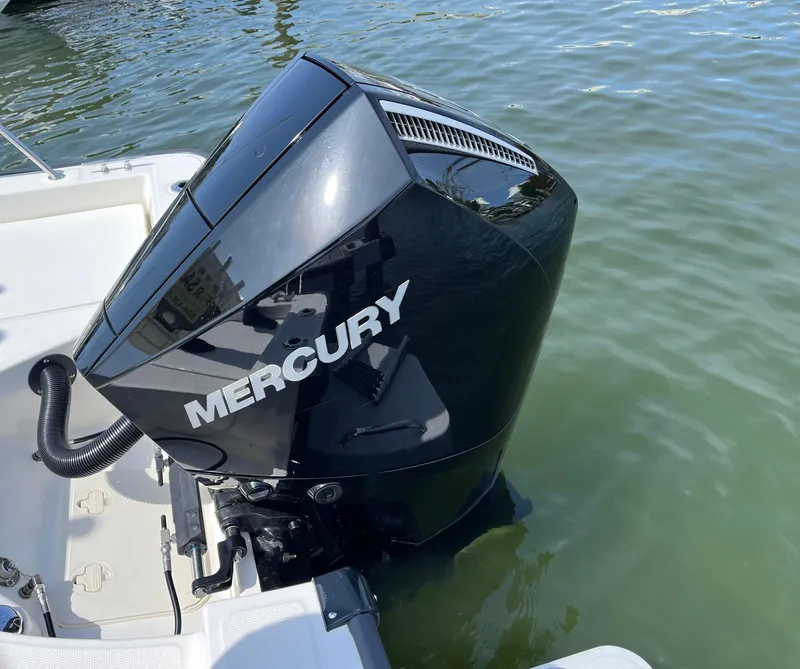 Slide: The Image of 2024 Boston Whaler 210 Montauk with Mercury outboard engine on water. - 2