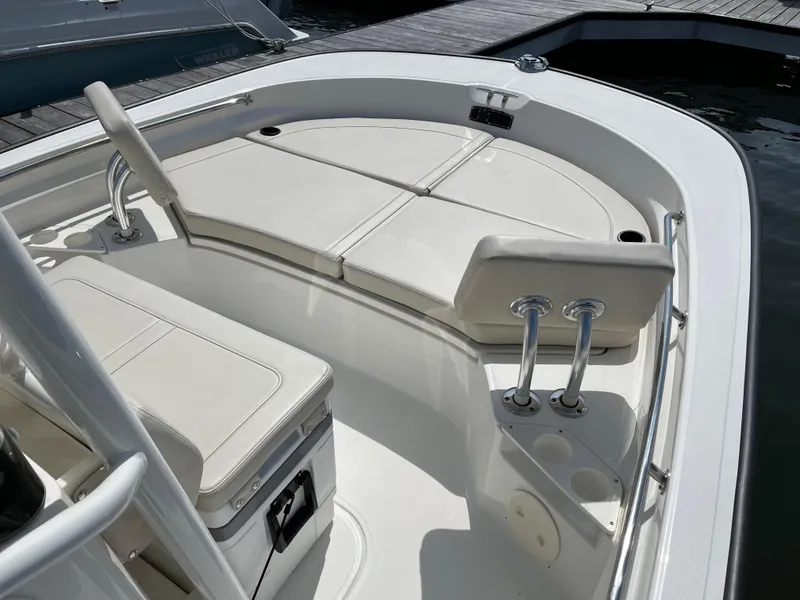 Slide: The Image of 2024 Boston Whaler 210 Montauk boat interior with cushioned seating and storage. - 21