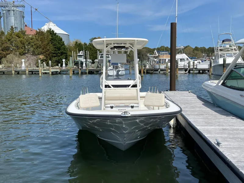 Slide: The Image of 2024 Boston Whaler 210 Montauk boat docked in a marina. - 24