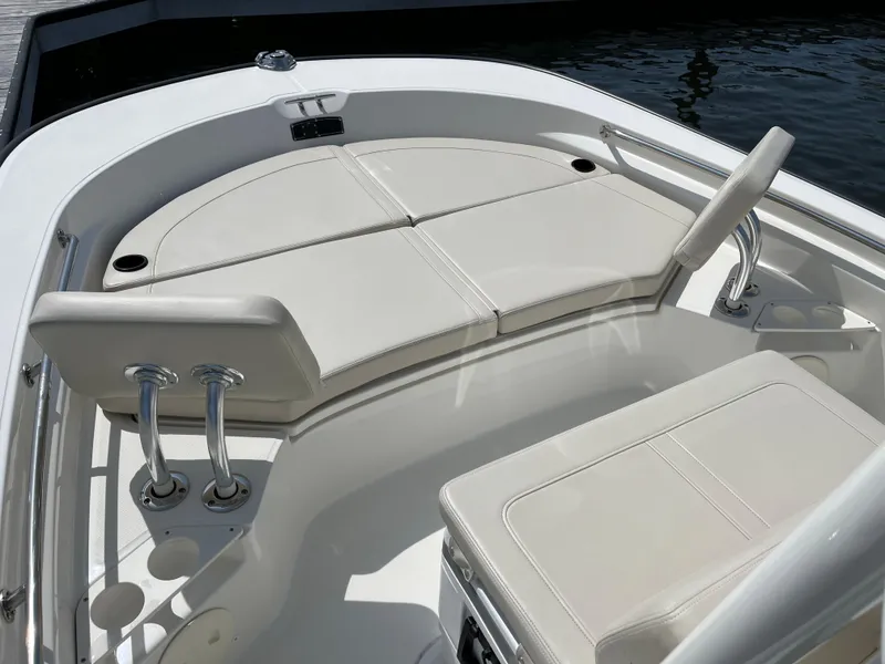 Slide: The Image of 2024 Boston Whaler 210 Montauk boat interior with cushioned seating and sleek design. - 8
