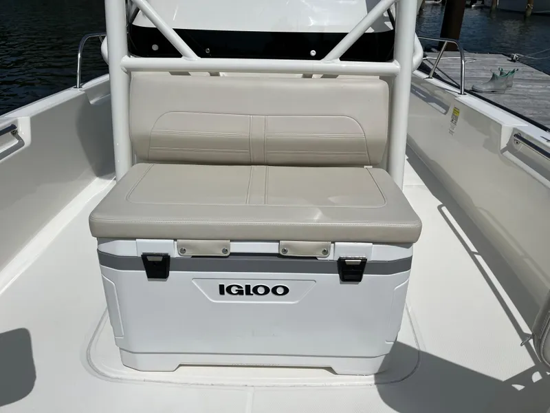 Slide: The Image of 2024 Boston Whaler 210 Montauk boat with Igloo cooler and cushioned seat. - 9