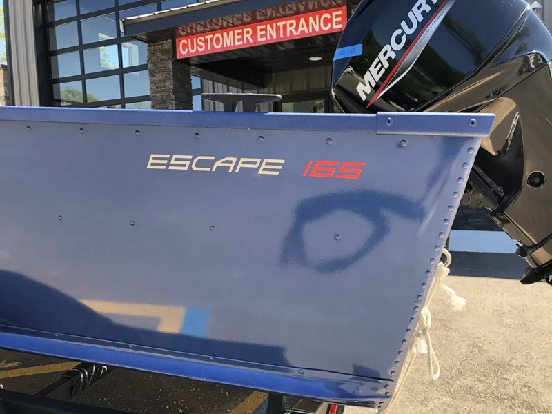 Slide: The Image of 2024 Alumacraft 165 Escape CS boat with Mercury engine at customer entrance. - 4