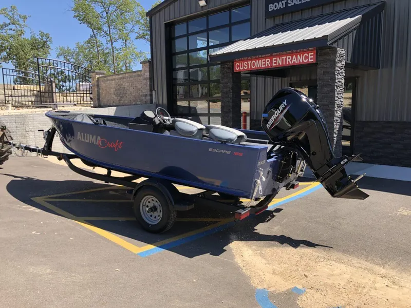 Slide: The Image of 2024 Alumacraft 165 Escape CS boat on trailer outside dealership. - 5