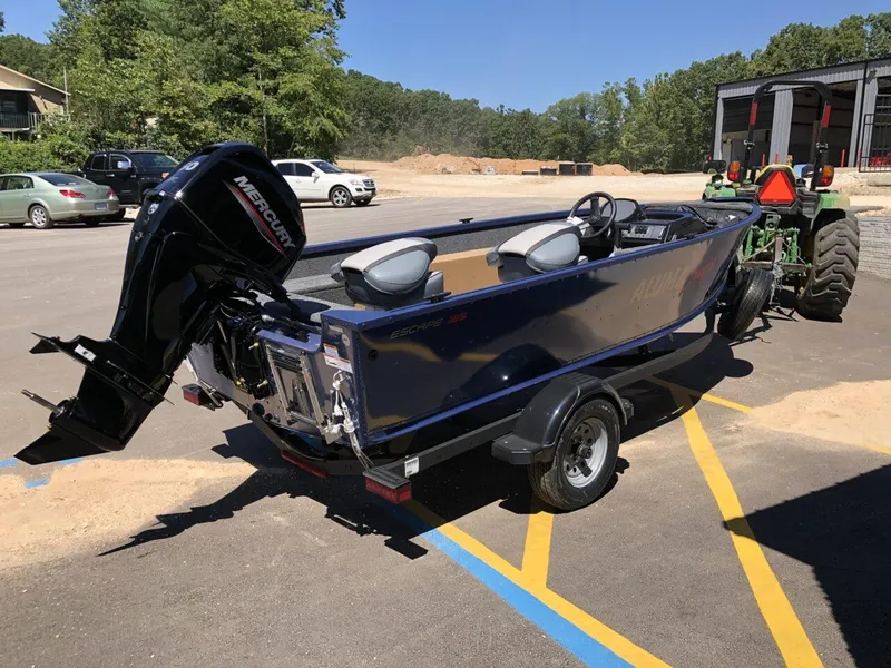 Slide: The Image of 2024 Alumacraft 165 Escape CS boat with Mercury outboard motor on trailer. - 7