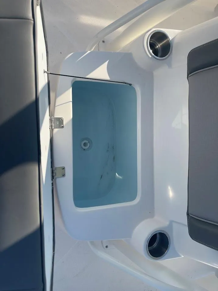 Slide: The Image of 2024 Sea Born LX 24 LE boat interior with open storage compartment. - 10