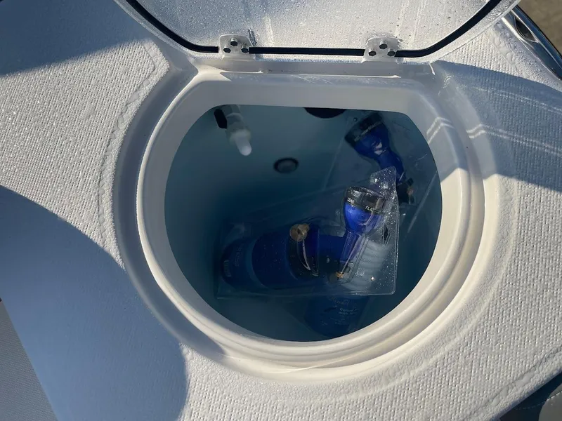 Slide: The Image of 2024 Sea Born LX 24 LE livewell with blue hoses and fittings. - 13