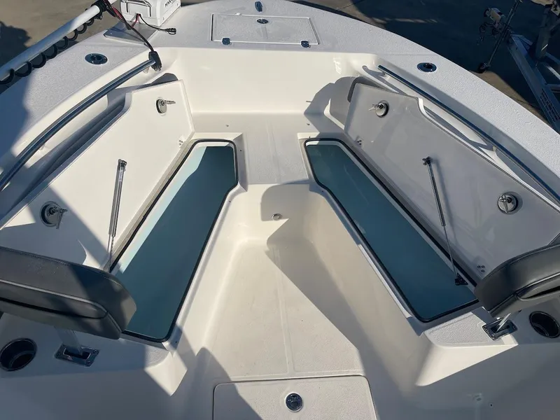 Slide: The Image of 2024 Sea Born LX 24 LE boat with open storage compartments. - 9