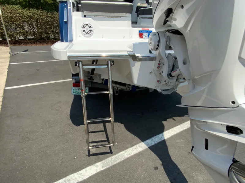 Slide: The Image of 2025 Cobalt R6 Outboard boat with ladder and motor in parking lot. - 11