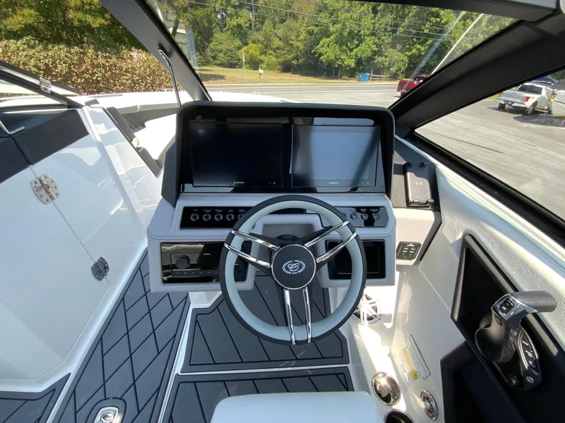 Slide: The Image of 2025 Cobalt R6 Outboard boat cockpit with modern steering and dual screens. - 15