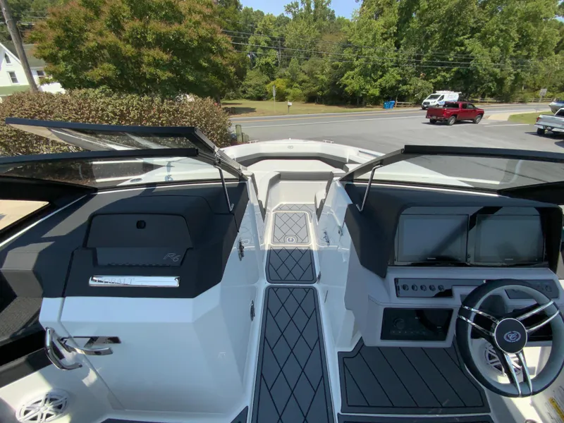 Slide: The Image of 2025 Cobalt R6 Outboard boat interior with sleek dashboard and steering wheel. - 19