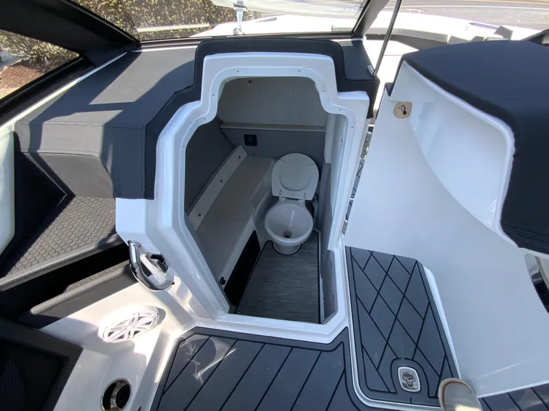 Slide: The Image of 2025 Cobalt R6 Outboard boat interior with compact marine toilet. - 25