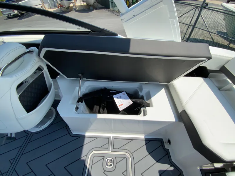 Slide: The Image of 2025 Cobalt R6 Outboard boat interior with open storage compartment and modern seating. - 29