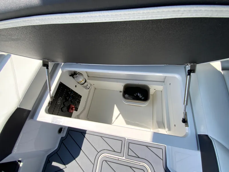 Slide: The Image of 2025 Cobalt R6 Outboard storage compartment with safety equipment and clean design. - 30