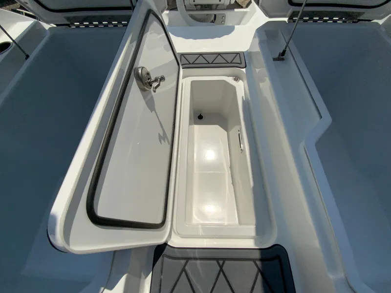 Slide: The Image of 2025 Cobalt R6 Outboard boat storage compartment with open lid. - 32