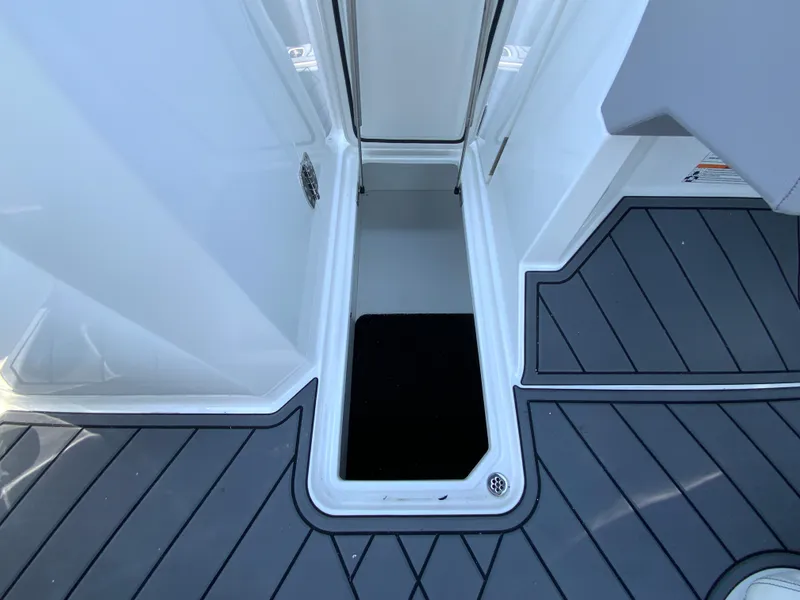 Slide: The Image of 2025 Cobalt R6 Outboard boat storage compartment with sleek gray flooring. - 35