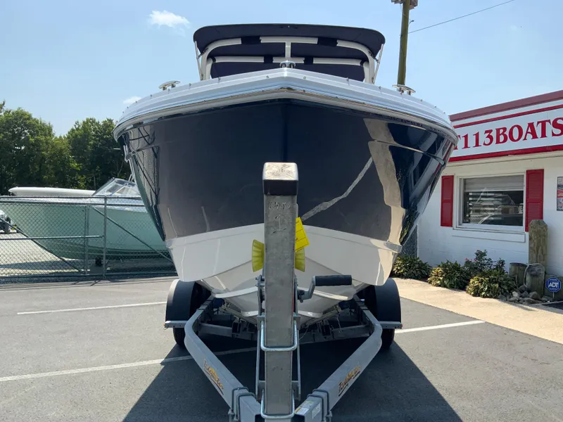 Slide: The Image of 2025 Cobalt R6 Outboard boat on trailer, parked outside dealership. - 4